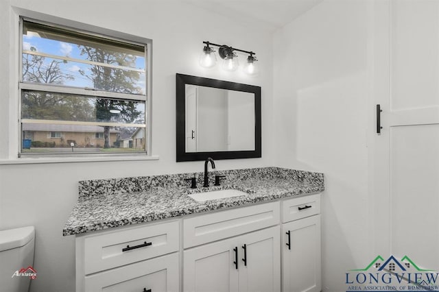 bathroom featuring toilet and vanity