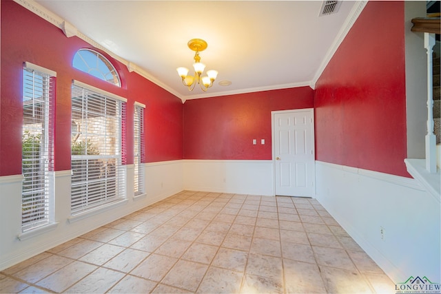 empty room featuring visible vents, tile patterned flooring, wainscoting, crown molding, and a notable chandelier