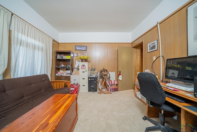 carpeted home office featuring wooden walls