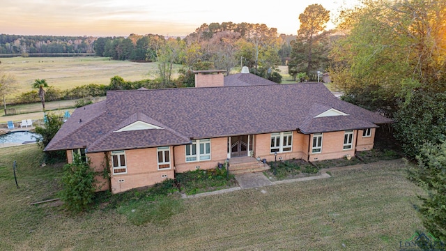 ranch-style home featuring a lawn