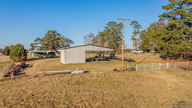 view of yard featuring an outbuilding and a rural view