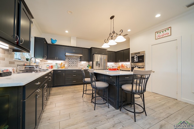 kitchen with sink, a center island, light hardwood / wood-style flooring, stainless steel refrigerator with ice dispenser, and pendant lighting