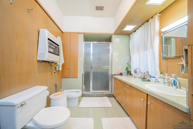 bathroom with vanity, a bidet, toilet, walk in shower, and heating unit