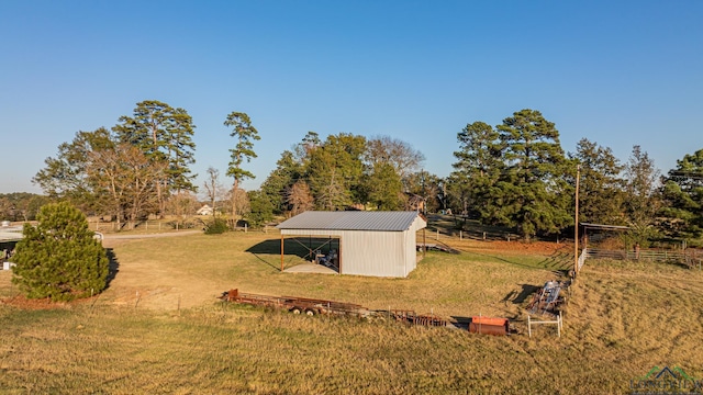 view of yard featuring an outbuilding and a rural view