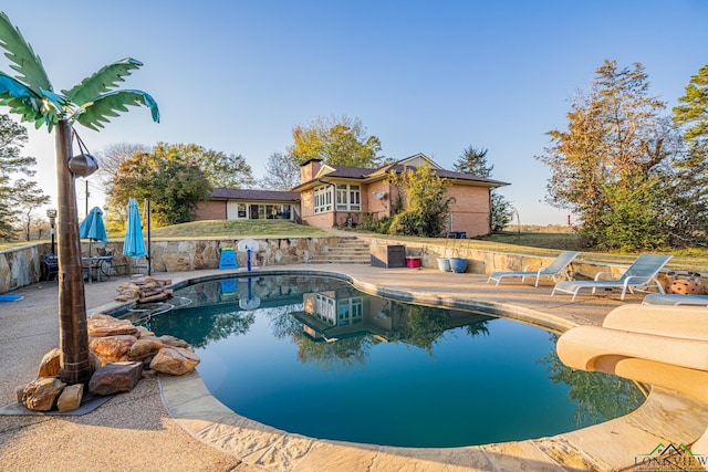 view of pool featuring a patio