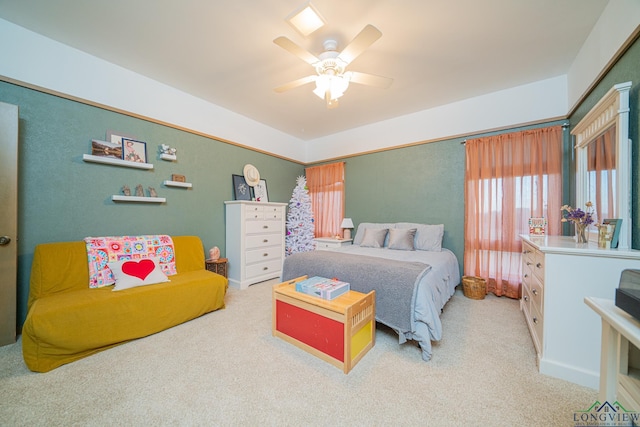 bedroom featuring light colored carpet and ceiling fan