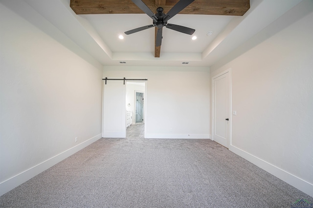 carpeted spare room with beamed ceiling and ceiling fan