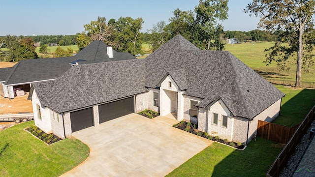 view of front of house featuring a front yard and a garage