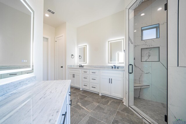 bathroom featuring vanity and a shower with shower door