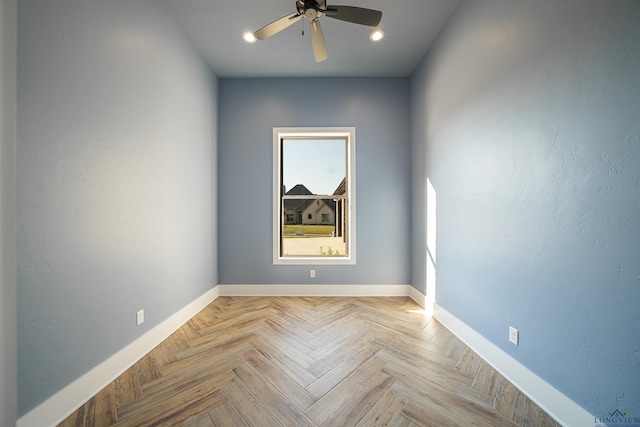 unfurnished room featuring ceiling fan and light parquet floors