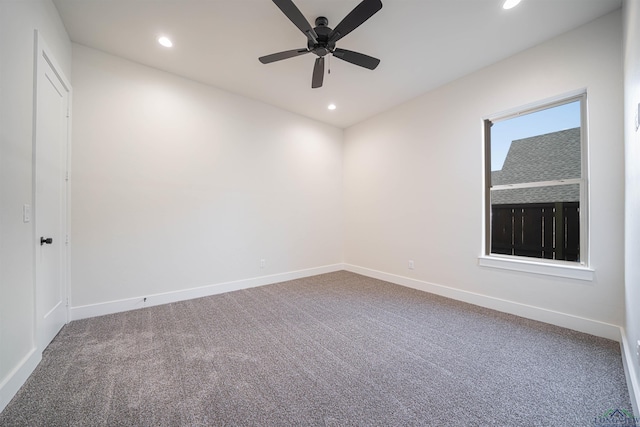 carpeted spare room featuring ceiling fan