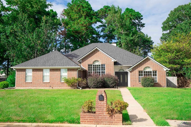 single story home featuring a front lawn