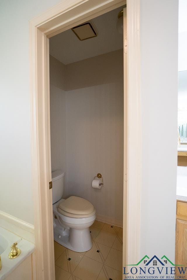 bathroom with tile patterned floors, vanity, and toilet