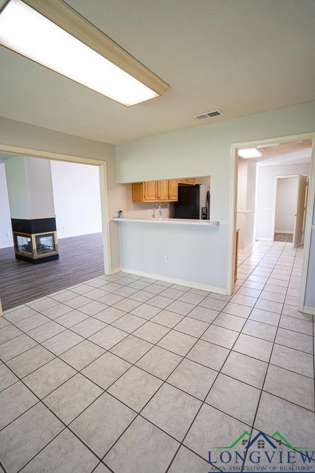 unfurnished living room featuring light tile patterned flooring