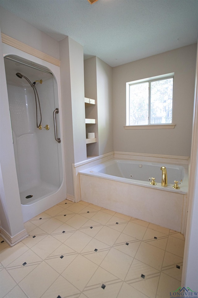 bathroom featuring tile patterned flooring, built in shelves, a textured ceiling, and plus walk in shower