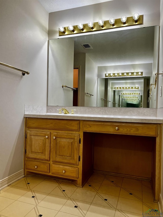 bathroom featuring tile patterned flooring and vanity