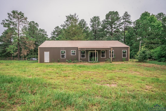 view of front of house with a front lawn and an outdoor structure