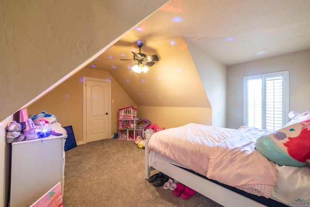 carpeted bedroom with ceiling fan and lofted ceiling