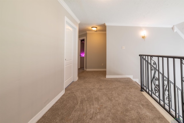 corridor featuring light colored carpet and ornamental molding