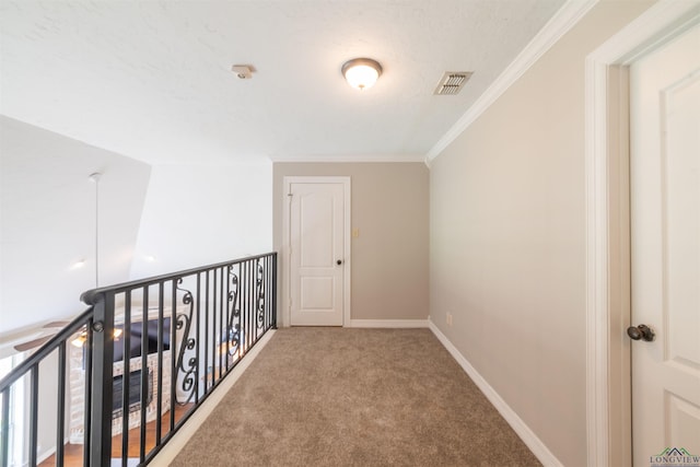 hall featuring crown molding, carpet floors, and a textured ceiling