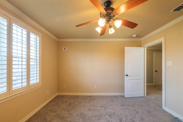 empty room with ceiling fan, light colored carpet, and ornamental molding