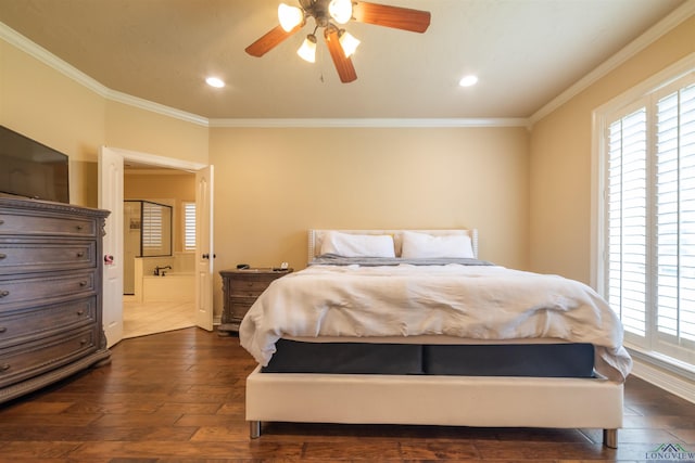 bedroom featuring dark hardwood / wood-style flooring, ensuite bathroom, ceiling fan, and crown molding