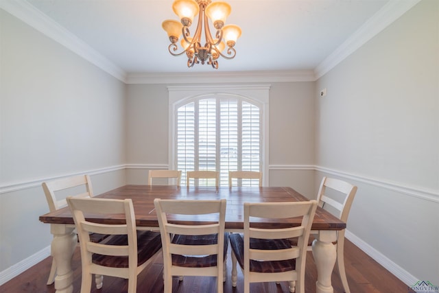 dining space featuring crown molding, dark wood-type flooring, and a chandelier