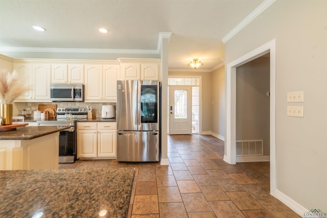 kitchen with tasteful backsplash, dark stone countertops, appliances with stainless steel finishes, light tile patterned flooring, and ornamental molding