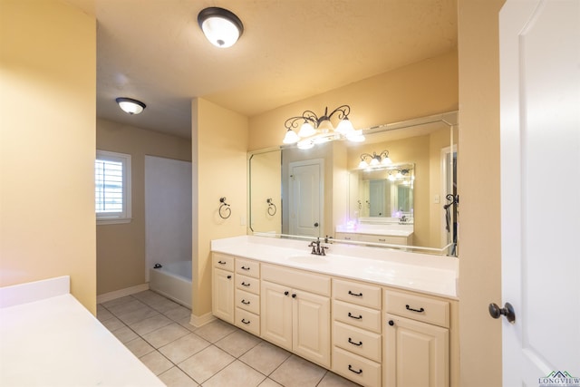 bathroom featuring tile patterned flooring, vanity, and a tub to relax in