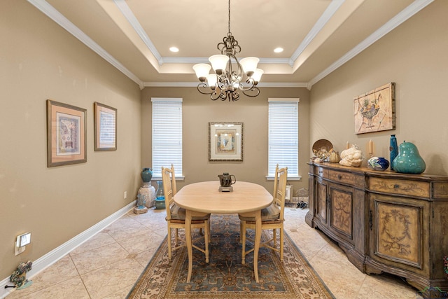 tiled dining room featuring a notable chandelier, ornamental molding, and a tray ceiling