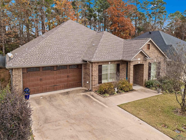 view of front of property with a garage and a front lawn