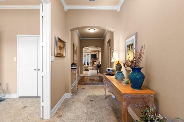 corridor featuring light tile patterned flooring and crown molding