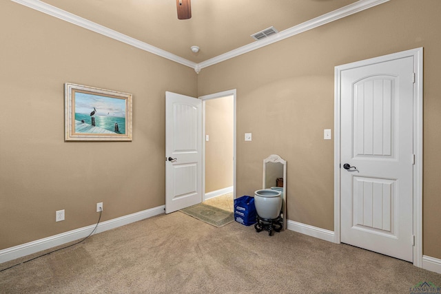 interior space featuring light colored carpet, ceiling fan, and ornamental molding