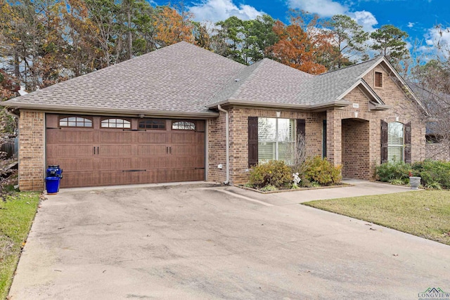 view of front of property with a front lawn and a garage