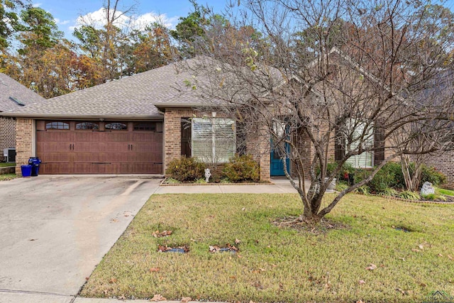 view of front of home with a front lawn and a garage