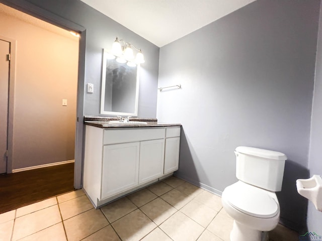 bathroom featuring tile patterned flooring, vanity, and toilet