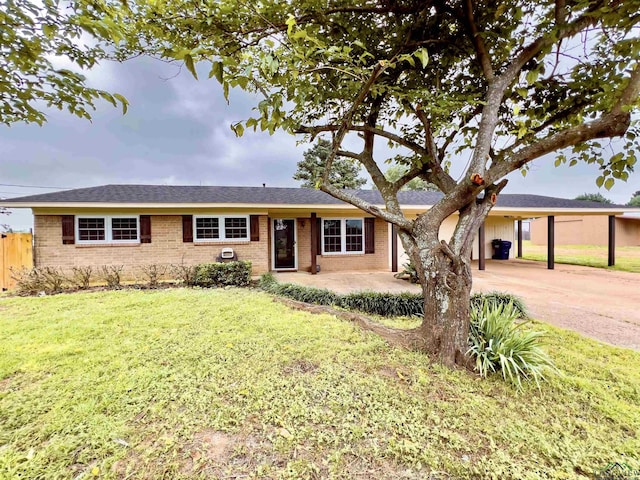 ranch-style house featuring a front yard and a carport