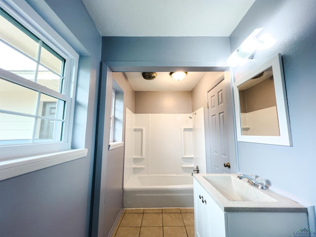 bathroom featuring tile patterned flooring, vanity, a textured ceiling, and bathing tub / shower combination