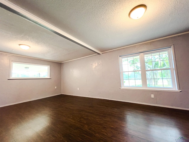 empty room featuring beam ceiling, crown molding, dark hardwood / wood-style flooring, and a textured ceiling