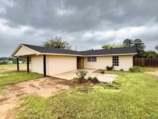 view of front of house with a patio area and a front yard