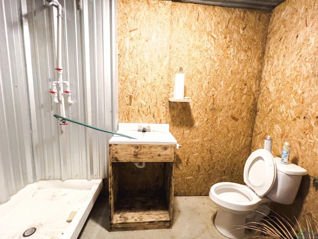 bathroom with vanity, toilet, and walk in shower