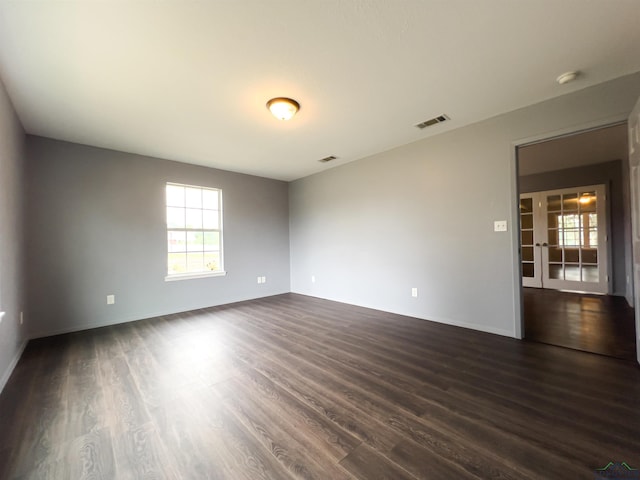 spare room featuring dark hardwood / wood-style flooring