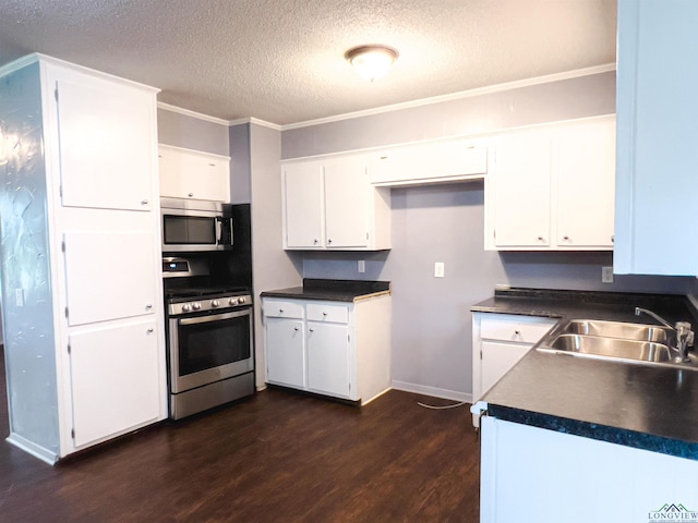 kitchen with a textured ceiling, stainless steel appliances, dark wood-type flooring, sink, and white cabinetry