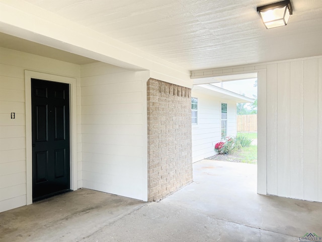 view of exterior entry with a patio area