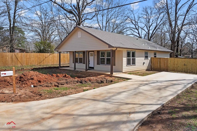 view of front facade with a porch and fence