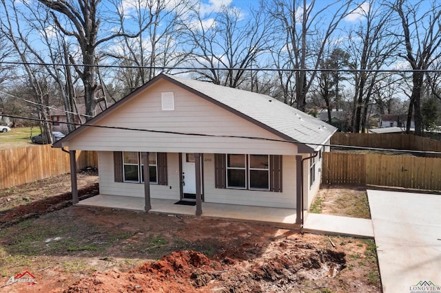 bungalow featuring fence private yard and covered porch