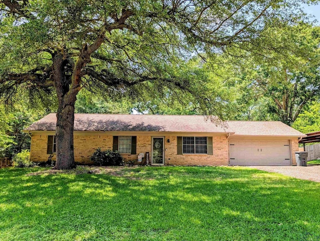 ranch-style house with a front lawn, brick siding, a shingled roof, an attached garage, and driveway