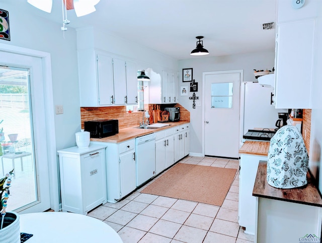 kitchen with a ceiling fan, backsplash, light tile patterned floors, white cabinets, and white appliances