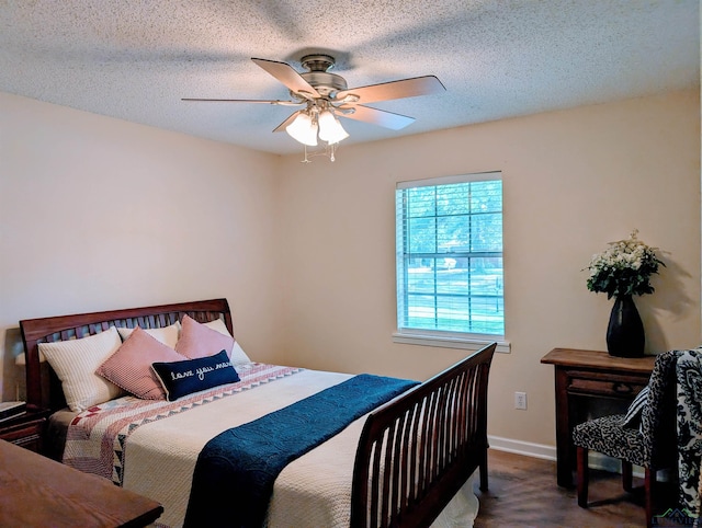bedroom featuring a ceiling fan, baseboards, and a textured ceiling