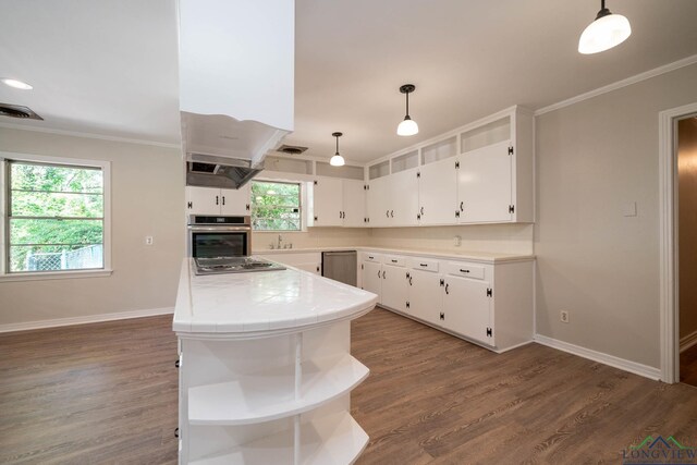 601 Wood St, Gladewater, TX 75647 - kitchen with open shelves, appliances with stainless steel finishes, tile counters, a sink, and white cabinetry